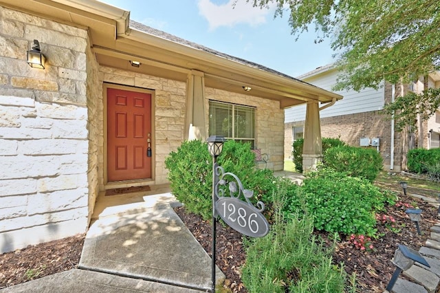 1286 Talley Loop, Buda, TX 78610 - entrance to property featuring stone siding and covered porch