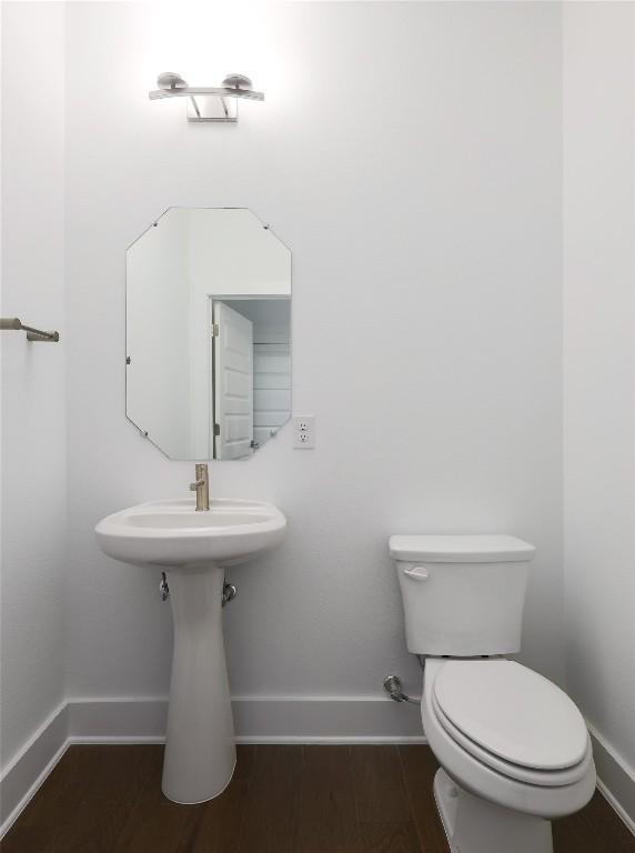 4703 Unity Cir Unit 284, Austin, TX 78731 - half bathroom featuring baseboards, toilet, and wood finished floors