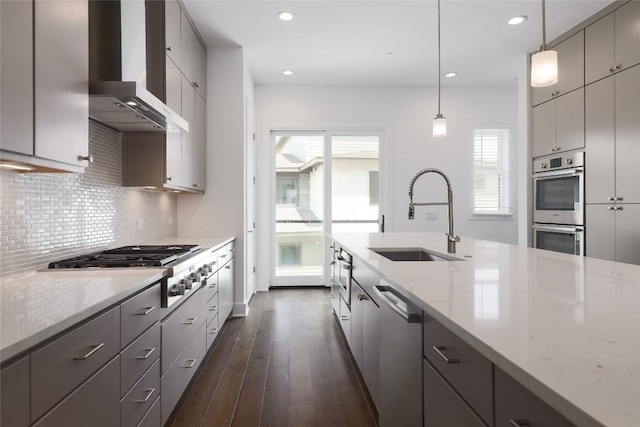 4703 Unity Cir Unit 284, Austin, TX 78731 - kitchen featuring a sink, wall chimney range hood, stainless steel appliances, gray cabinetry, and plenty of natural light