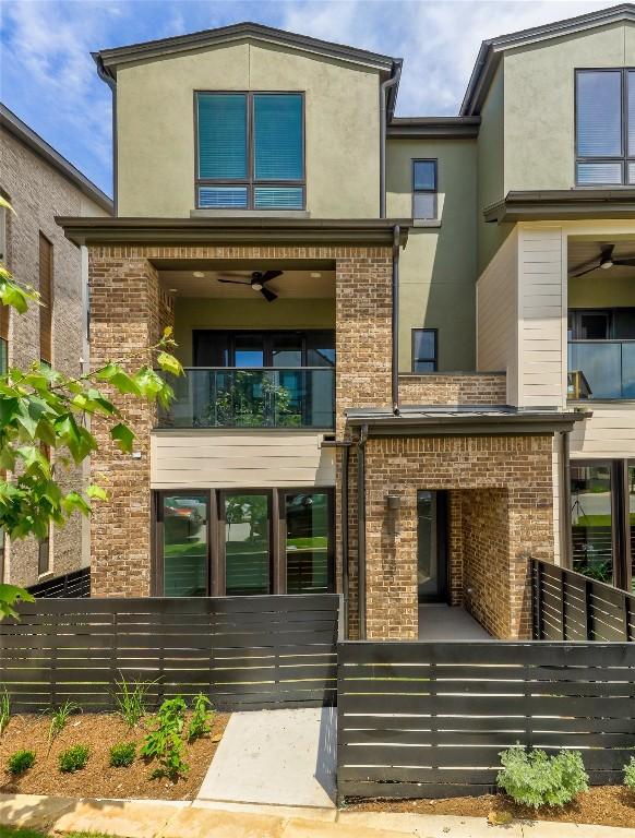 4703 Unity Cir Unit 284, Austin, TX 78731 - view of front of property with a balcony, ceiling fan, brick siding, and stucco siding