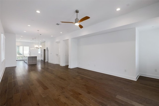 4703 Unity Cir Unit 284, Austin, TX 78731 - unfurnished living room with a chandelier, a ceiling fan, dark wood-type flooring, recessed lighting, and baseboards