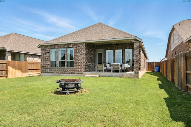 112 Rosemary Ct, Bastrop, TX 78602 - rear view of house featuring brick siding, a shingled roof, a ceiling fan, an outdoor living space with a fire pit, and a patio