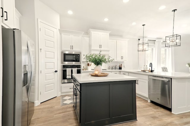 112 Rosemary Ct, Bastrop, TX 78602 - kitchen with appliances with stainless steel finishes, a sink, a peninsula, white cabinetry, and decorative backsplash