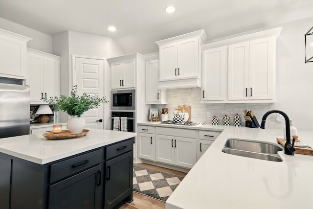 112 Rosemary Ct, Bastrop, TX 78602 - kitchen featuring a sink, white cabinetry, stainless steel appliances, light countertops, and recessed lighting