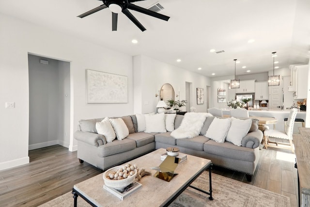 112 Rosemary Ct, Bastrop, TX 78602 - living room featuring ceiling fan, light wood-type flooring, recessed lighting, baseboards, and a chandelier