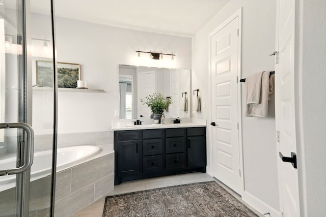 112 Rosemary Ct, Bastrop, TX 78602 - bathroom with double vanity, a bath, tile patterned floors, and a stall shower