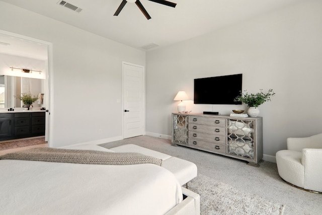 112 Rosemary Ct, Bastrop, TX 78602 - carpeted bedroom with connected bathroom, baseboards, and ceiling fan