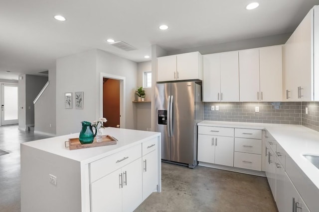 4020 Airport Blvd Unit 9, Austin, TX 78722 - kitchen featuring stainless steel refrigerator with ice dispenser, concrete floors, decorative backsplash, light countertops, and white cabinetry
