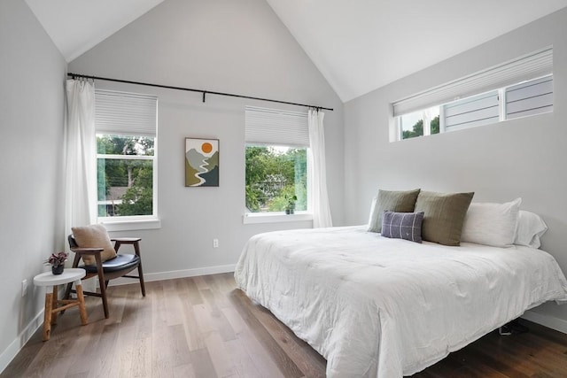 4020 Airport Blvd Unit 9, Austin, TX 78722 - bedroom featuring high vaulted ceiling, baseboards, and wood finished floors