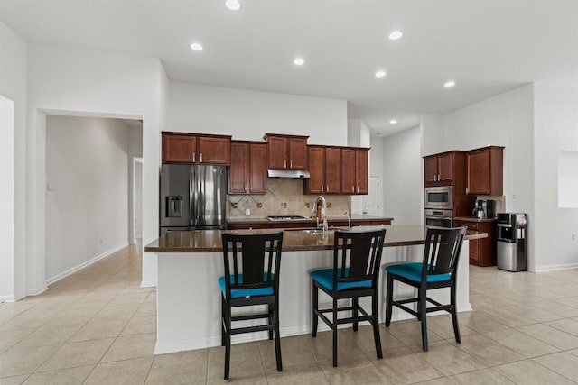 13708 Field Stream Ln, Manor, TX 78653 - kitchen featuring stainless steel appliances, a sink, backsplash, light tile patterned floors, and dark countertops