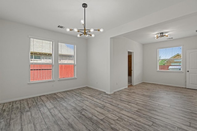 13708 Field Stream Ln, Manor, TX 78653 - unfurnished room with a chandelier, wood finished floors, and baseboards