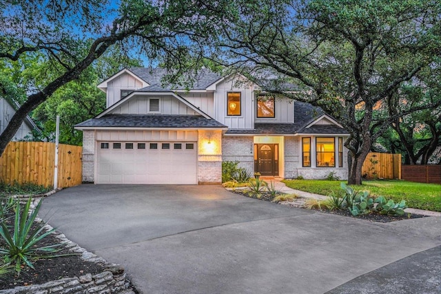 1704 Prairie Hen Cv, Austin, TX 78758 - view of front of property featuring driveway, a garage, board and batten siding, and roof with shingles