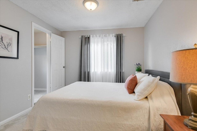 1704 Prairie Hen Cv, Austin, TX 78758 - carpeted bedroom featuring a textured ceiling and baseboards