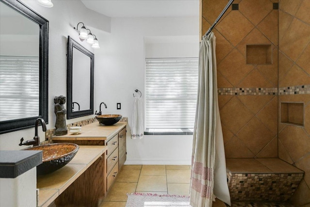 1704 Prairie Hen Cv, Austin, TX 78758 - bathroom with double vanity, tile patterned floors, and tiled shower