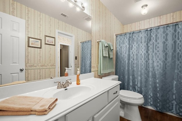 6109 Pebble Garden Ct, Austin, TX 78739 - bathroom featuring wallpapered walls, toilet, vanity, wood finished floors, and a shower with shower curtain