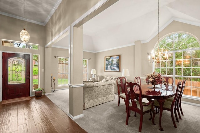 6109 Pebble Garden Ct, Austin, TX 78739 - dining area featuring a chandelier, wood finished floors, plenty of natural light, ornamental molding, and high vaulted ceiling