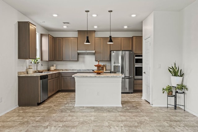 18517 Spotted Eagle Ln, Elgin, TX 78621 - kitchen with stainless steel appliances, a kitchen island, light stone countertops, decorative light fixtures, and recessed lighting