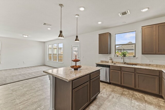 18517 Spotted Eagle Ln, Elgin, TX 78621 - kitchen with dishwasher, open floor plan, light countertops, light colored carpet, and a kitchen island