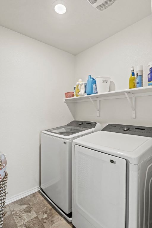 18517 Spotted Eagle Ln, Elgin, TX 78621 - washroom with separate washer and dryer and baseboards