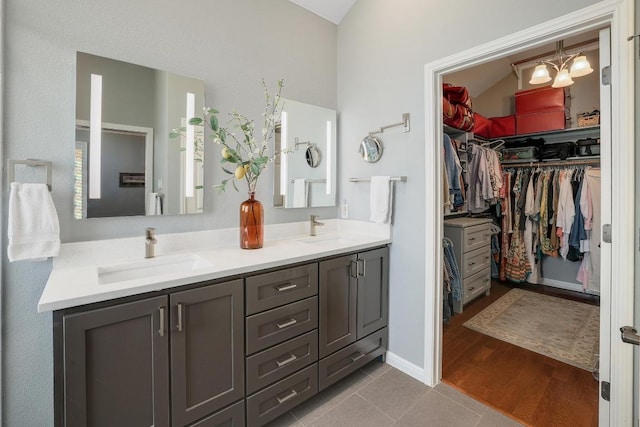 2517 Moray Ln, Cedar Park, TX 78613 - bathroom with double vanity, a spacious closet, and tile patterned floors