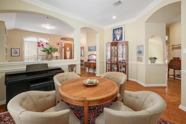 2517 Moray Ln, Cedar Park, TX 78613 - dining area featuring wood finished floors, arched walkways, baseboards, ornamental molding, and recessed lighting