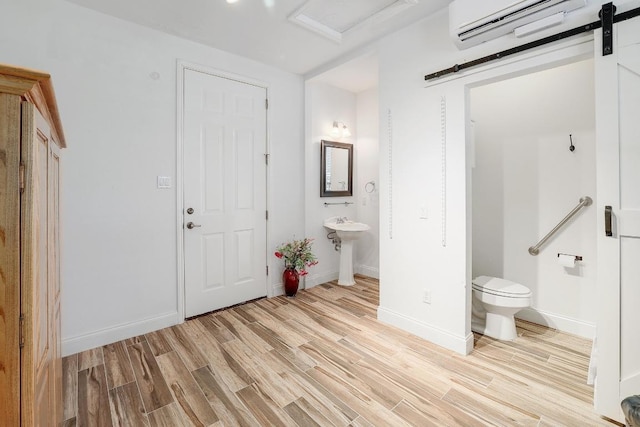 2517 Moray Ln, Cedar Park, TX 78613 - foyer entrance with light wood-type flooring, a wall mounted AC, a barn door, and baseboards
