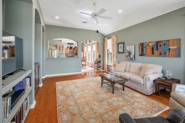 2517 Moray Ln, Cedar Park, TX 78613 - living room with arched walkways, ceiling fan, wood finished floors, lofted ceiling, and baseboards