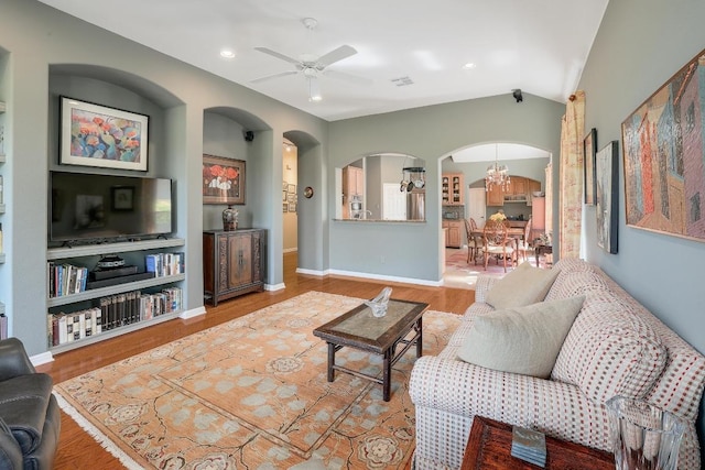 2517 Moray Ln, Cedar Park, TX 78613 - living area featuring arched walkways, a chandelier, a ceiling fan, wood finished floors, and recessed lighting