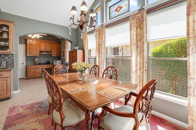 2517 Moray Ln, Cedar Park, TX 78613 - dining area with arched walkways, a chandelier, light tile patterned floors, and baseboards
