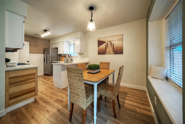 615 Twin Oak Trl, Cedar Park, TX 78613 - dining area featuring a textured ceiling and light wood-type flooring