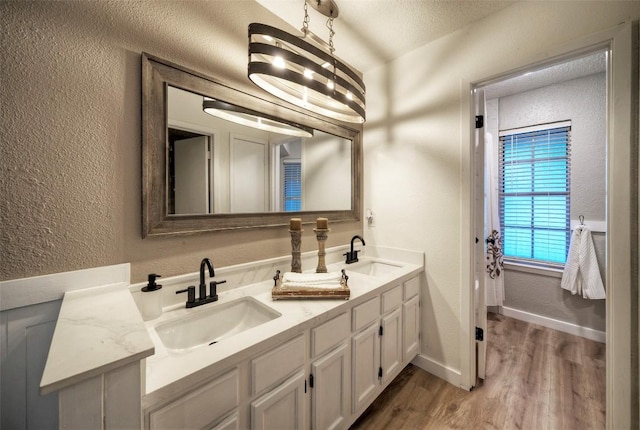 615 Twin Oak Trl, Cedar Park, TX 78613 - full bath with a textured wall, double vanity, wood finished floors, and a textured ceiling