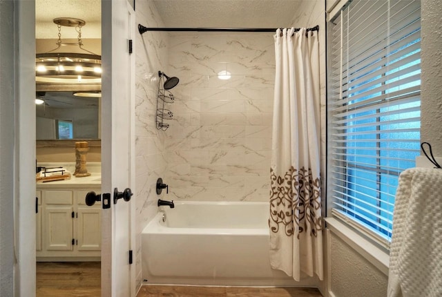 615 Twin Oak Trl, Cedar Park, TX 78613 - full bath featuring shower / bathtub combination with curtain, wood finished floors, vanity, a textured ceiling, and a ceiling fan