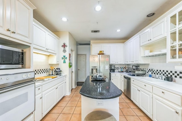 909 Oak Meadow Dr, Dripping Springs, TX 78620 - kitchen with appliances with stainless steel finishes, decorative backsplash, white cabinets, and recessed lighting