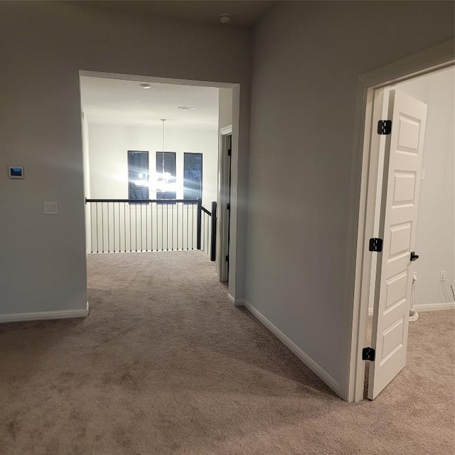 6833 Destination Way, Lago Vista, TX 78645 - corridor featuring light colored carpet, baseboards, and a chandelier