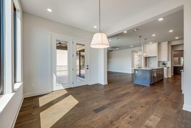 6833 Destination Way, Lago Vista, TX 78645 - kitchen with open floor plan, dark wood-type flooring, healthy amount of natural light, white cabinetry, and recessed lighting