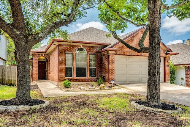 14710 Montoro Dr, Austin, TX 78728 - view of front of house featuring a garage, driveway, brick siding, and a shingled roof