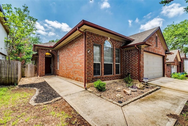 14710 Montoro Dr, Austin, TX 78728 - single story home with brick siding, an attached garage, roof with shingles, and driveway