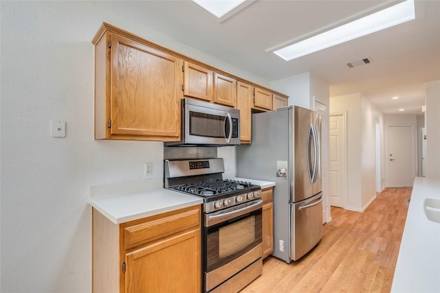 14710 Montoro Dr, Austin, TX 78728 - kitchen featuring stainless steel appliances, light wood finished floors, light countertops, and recessed lighting