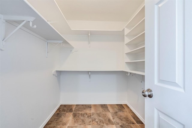 14710 Montoro Dr, Austin, TX 78728 - walk in closet featuring stone finish flooring