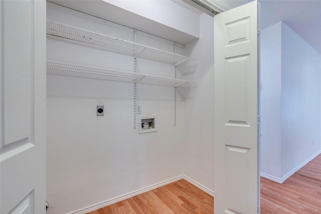 14710 Montoro Dr, Austin, TX 78728 - laundry room featuring hookup for an electric dryer, light wood-style floors, washer hookup, and baseboards