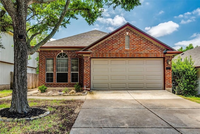 14710 Montoro Dr, Austin, TX 78728 - view of front of home with brick siding, driveway, roof with shingles, and a garage