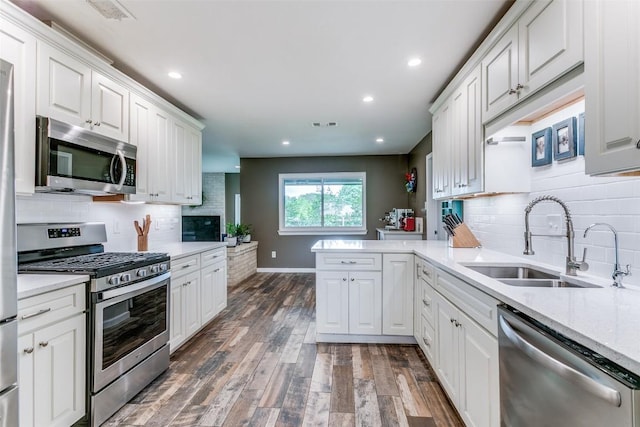 110 Fleetwood Dr, New Braunfels, TX 78130 - kitchen with stainless steel appliances, dark wood-type flooring, white cabinets, and recessed lighting