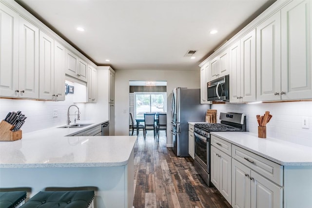 110 Fleetwood Dr, New Braunfels, TX 78130 - kitchen featuring appliances with stainless steel finishes, dark wood-type flooring, light countertops, white cabinets, and recessed lighting