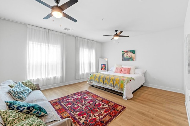 2500 Longview St Unit 112, Austin, TX 78705 - bedroom with wood finished floors, a ceiling fan, and baseboards