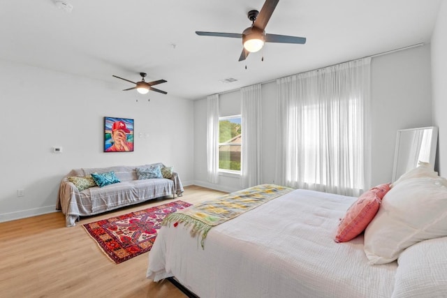 2500 Longview St Unit 112, Austin, TX 78705 - bedroom with light wood-style flooring, baseboards, and ceiling fan