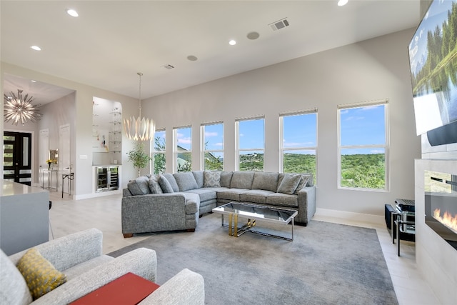 105 Golden Eagle, Horseshoe Bay, TX 78657 - living area with a glass covered fireplace, a high ceiling, plenty of natural light, recessed lighting, and baseboards