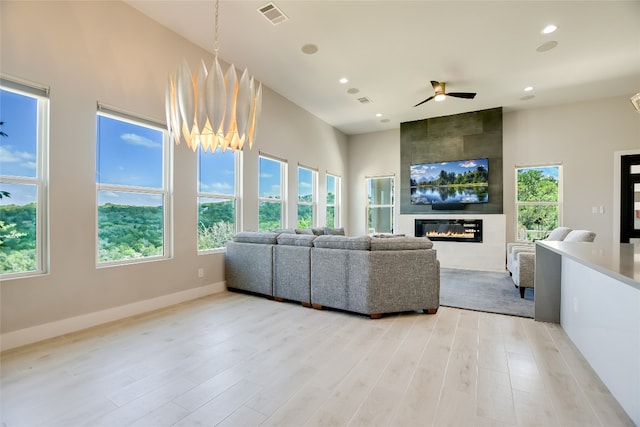 105 Golden Eagle, Horseshoe Bay, TX 78657 - living room with light wood-style flooring, a fireplace, recessed lighting, plenty of natural light, and a ceiling fan