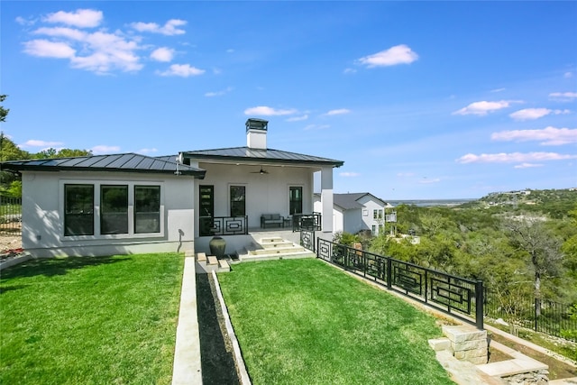 105 Golden Eagle, Horseshoe Bay, TX 78657 - rear view of house with a standing seam roof, a chimney, stucco siding, and a ceiling fan