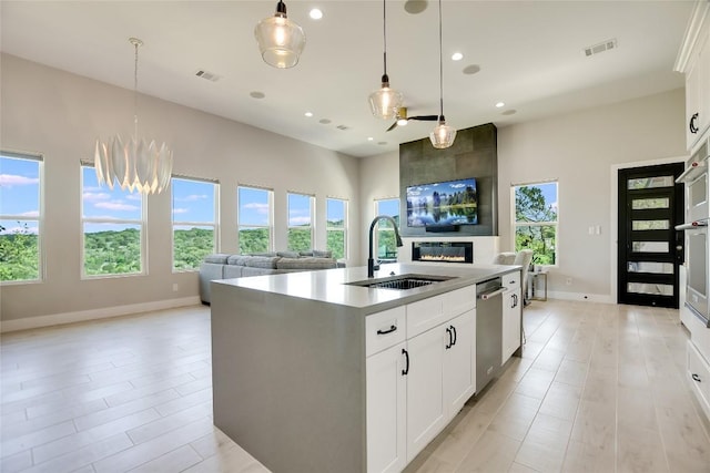 105 Golden Eagle, Horseshoe Bay, TX 78657 - kitchen with a sink, open floor plan, stainless steel dishwasher, recessed lighting, and baseboards