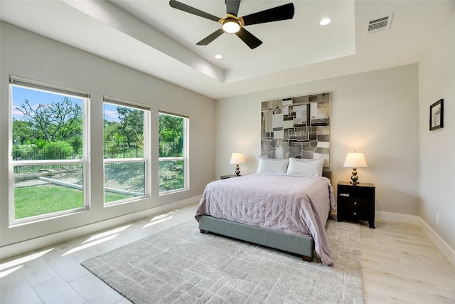 105 Golden Eagle, Horseshoe Bay, TX 78657 - bedroom with a tray ceiling, recessed lighting, baseboards, and ceiling fan